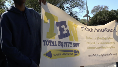 person holding banner with "ten total equity now" logo