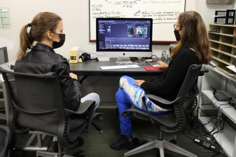 Instructor showing student how to work with editing software