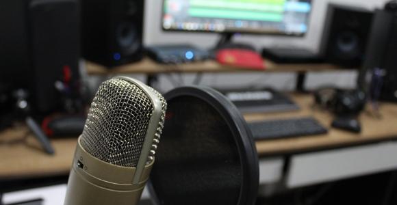 Home Podcasting setup with Mic, Computer, and Speakers
