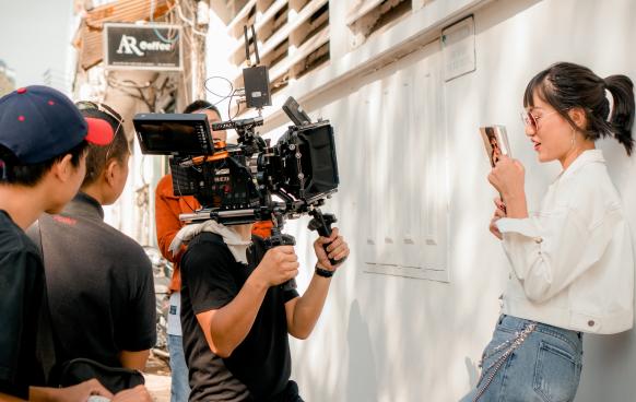 Film crew filming woman