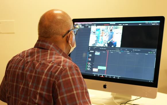 Student at a computer working with the DaVinci Resolve video editing software.