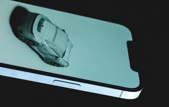 photo of an iphone screen displaying a 3d wireframe model of a sports car.